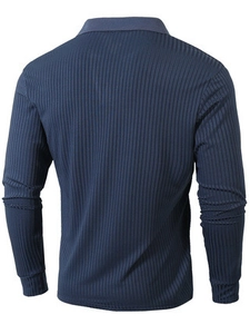 Detail of navy blue long sleeve polo showing the vertical ribbed knit fabric texture on the back