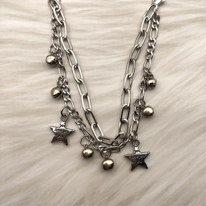 Silver double-layer star bracelet with bells and Love You engraving on a plush background