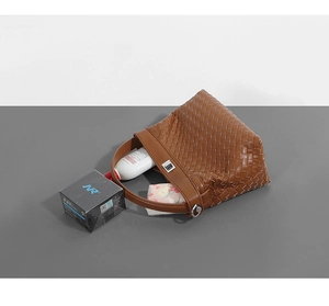 Detail view of brown woven tote bag interior showing large capacity for personal items