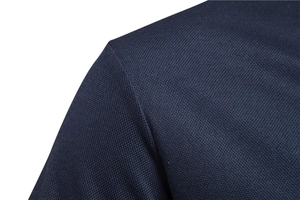 Close-up of deep blue high-density cotton fabric with refined twill weave on polo shoulder