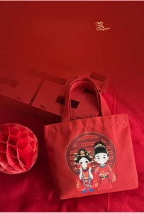 Detail of red wedding canvas tote bag featuring cute cartoon bride and groom illustration