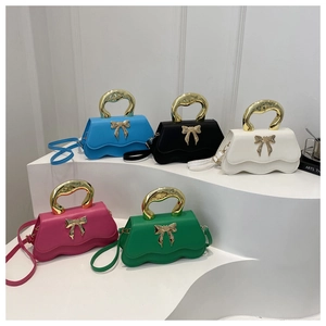 Stylish wavy handbag with bow accent and metal handle in five pastel colors