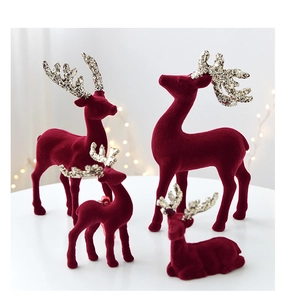 Macro view of Christmas reindeer ornaments in burgundy flocking with sparkling glitter antlers