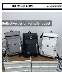 Detailed view of large travel backpacks in gray, black, and white with reflective strips