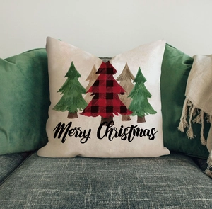 Macro shot of a Christmas pillow with a plaid tree on a sofa for home decor