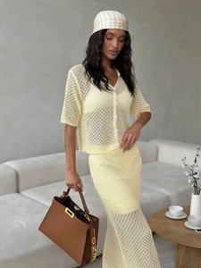 Two-piece yellow knit set with short sleeve cardigan and hollow-out crochet long skirt