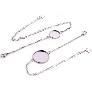 Macro detail of silver stainless steel bracelet tray with star charm and lobster clasp