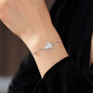 Detail of silver butterfly bracelet featuring white mother of pearl and zircon stones