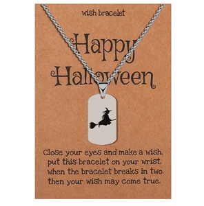 Detail of silver witch silhouette pendant on card with Happy Halloween greeting