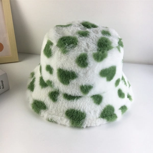 Close-up of soft white faux fur bucket hat featuring vibrant green heart patterns