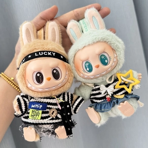 Detail of plush monster pendants featuring rabbit ear hats and striped doll outfits