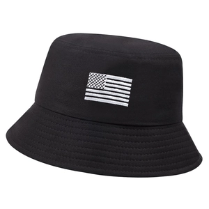 Black cotton bucket hat featuring white embroidered American flag on a plain white background