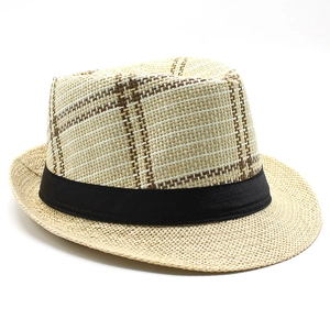 Detail view of a men's plaid straw fedora hat with a black ribbon band for summer vacations