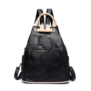 Multifunctional patchwork leather backpack in black and beige with a metallic logo plate