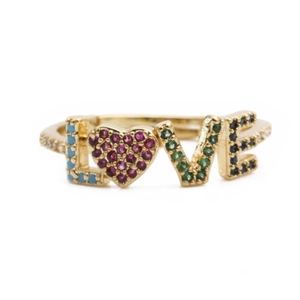 Close-up of golden LOVE ring featuring colorful gemstones and heart shaped details
