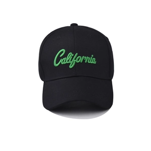 Detailed close-up of neon green California embroidery on black cotton baseball cap