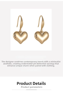 Detailed view of polished heart-shaped gold-plated earrings with minimalist ear hooks
