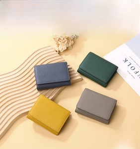 Flat lay of multiple leather trifold wallets with RFID protection and textured finish