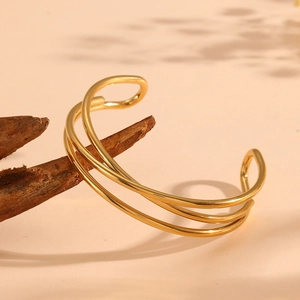 Detail showing the 18k gold plated triple-layer coiled stainless steel cuff bracelet