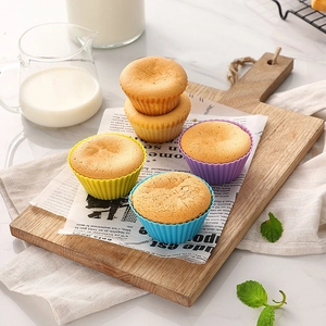 Top view of colorful silicone muffin cups on a wooden board for home baking