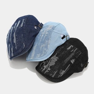 Vintage washed denim beret with distressed ripped holes in blue and black colors