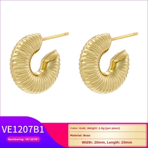 Detail view of gold brass spiral hoop earrings with dimensions 20mm x 20mm and 2g weight