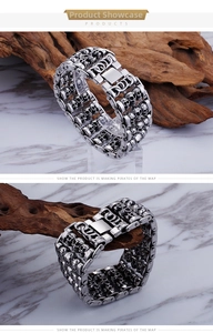 Detail of vintage silver skull bracelet with triple row punk design and folding clasp