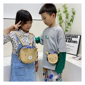 Detail of cute bear-shaped kids crossbody bag and backpack in soft khaki leather
