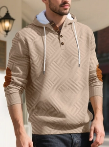 Detailed view of men's knit hoodie with brown elbow patches and buttoned neckline