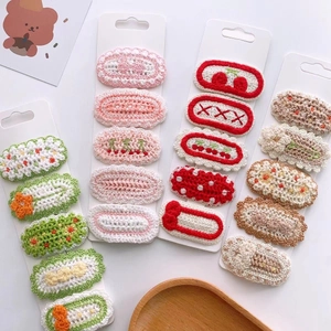 Handmade knitted flower hair clip set for women featuring colorful crochet cherry designs