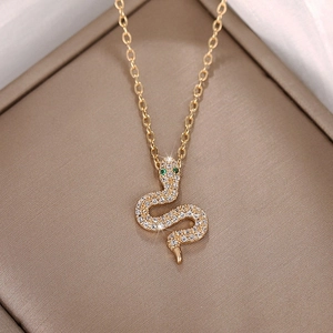 Luxury gold snake pendant necklace with sparkling zircons and green gemstone eyes