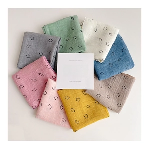 Detailed arrangement of soft cotton muslin baby bibs in eight assorted colors with smiley face
