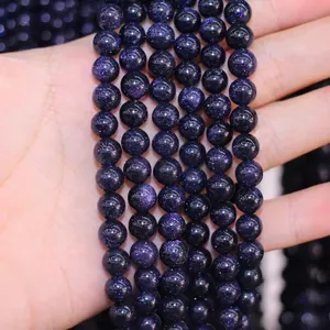 Macro shot of 8mm blue sandstone beads showing sparkling inclusions for DIY jewelry