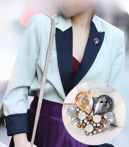 Detailed view of fashion crystal brooch pinned on clothes with model styling and macro shot