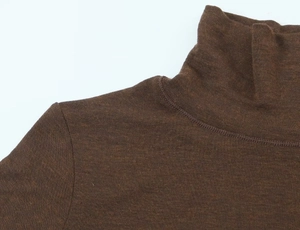 Close-up of the high neck and knit texture of a brown asymmetric short sleeve T-shirt