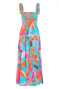 Detail of tiered skirt and tropical floral print on a smocked bohemian dress