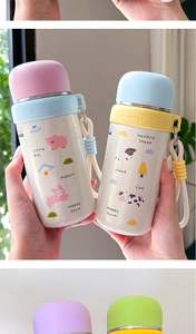 Detail of cute cartoon stainless steel water bottle with silicone carry strap and lid
