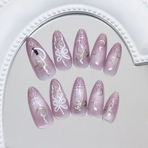 Cat eye purple press on nails with bow, moon, and star designs for a dreamy look