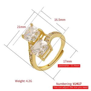 Adjustable gold ring with dual square zircons and side accents on a white background