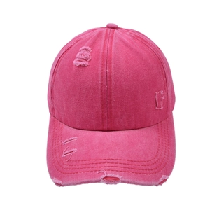 Detail of hot pink washed cotton baseball cap featuring vintage distressed torn edges