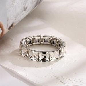 Close-up of geometric silver stretch bracelet with large square-cut sparkling crystals