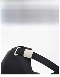 Detail of adjustable silver metal buckle and quick-dry strap on black baseball cap