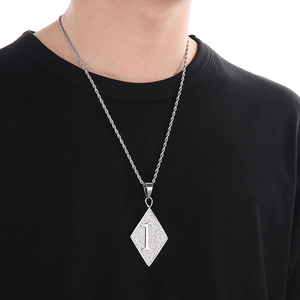Gros plan d'un collier avec pendentif losange 1%er argenté sur le cou d'un modèle masculin