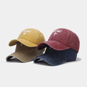 Detailed texture of washed cotton baseball caps with religious thermal print graphics