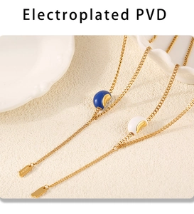Detailed close-up of blue and white beaded pendants with lucky tag on stainless steel necklace