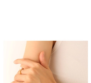 Close-up of elegant gold square ring with a white pearl on a model's finger