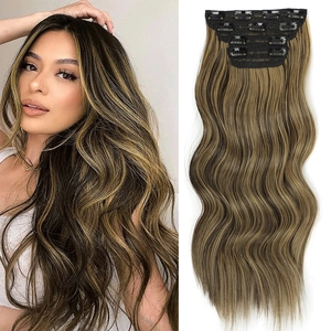 Detail view of wavy brown highlights clip-in hair extension set on a female model