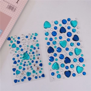 Close-up of blue and silver heart-shaped crystal rhinestone stickers for DIY decoration