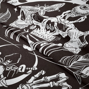Detailed view of gothic tapestry fabric showing skull, moth and celestial patterns