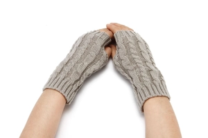 Macro detail of thick cable knit pattern on light grey fingerless winter gloves